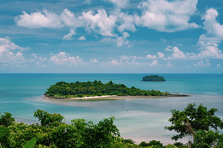 island with trees surrounded by ocean during daytime thumbnail