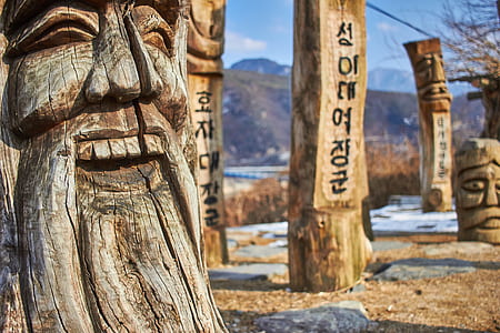 male person wood carving during daytime thumbnail