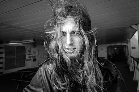 grayscale photo of man with long hair thumbnail