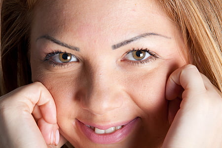 woman holding her cheeks thumbnail