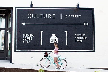 woman riding teal beach cruiser thumbnail
