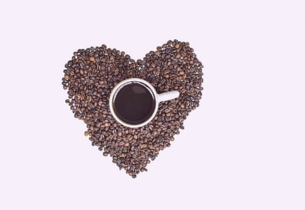 coffee in mug beside black coffee beans thumbnail