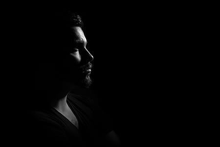 Grayscale Photo of Man in Black V Neck Shirt With Black Background thumbnail