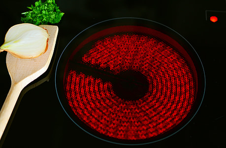 sliced onion on brown ladle beside frying pan thumbnail