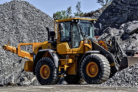 yellow and black front loader carrying gravel thumbnail