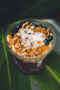 clear plastic cup on green leaves thumbnail