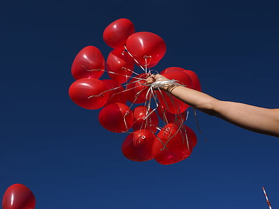 person holding helium balloons thumbnail