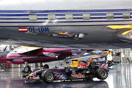 blue Redbull race car under plane thumbnail