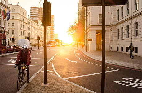 man wearing white bike helmet near light post thumbnail