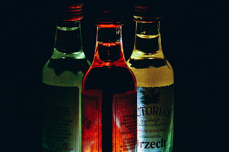 three assorted-color bottles in black background thumbnail