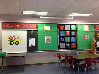 children's assorted art works posted on chalkboard thumbnail