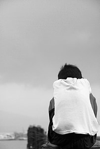 grayscale photography of sitting boy thumbnail