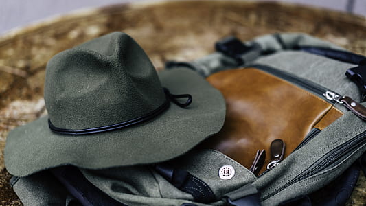 black cowboy hat on black and brown bag thumbnail