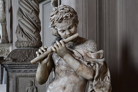 gray concrete person playing flute statue thumbnail
