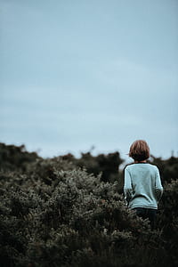 boy in teal long-sleeved shirt on grass thumbnail