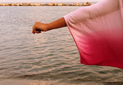 person's hand near body of water thumbnail