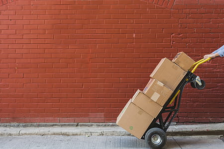 Shipping Boxes In Front Of Red Brick Photo thumbnail