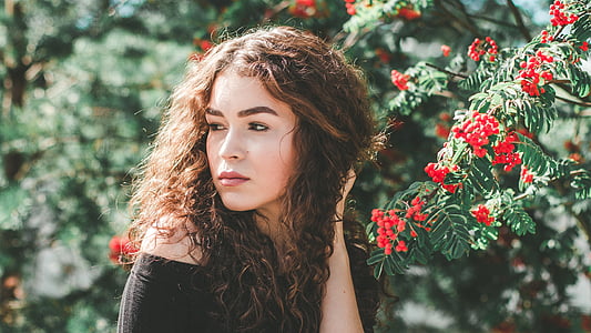 woman wearing black off-shoulder top beside green leaf tree thumbnail