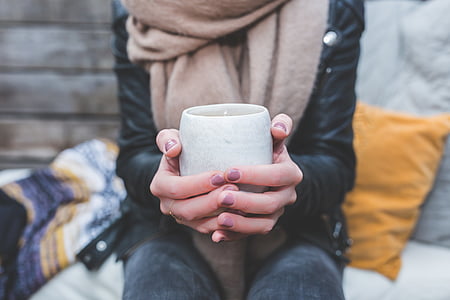 woman holding gray cup thumbnail