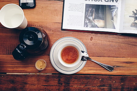 white saucer with spoon near cup on table thumbnail