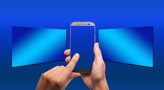 person holding gold HTC One M8 smartphone thumbnail