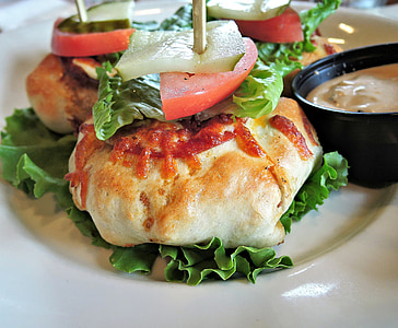 stuffed pastry with lettuce and tomatoes and dip in plate thumbnail