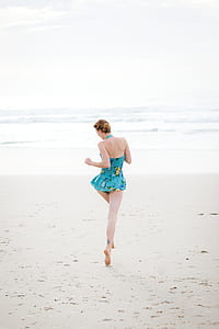 woman in blue bikini running through body of water thumbnail