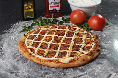 Baked Pizza Beside Two Red Tomatoes thumbnail