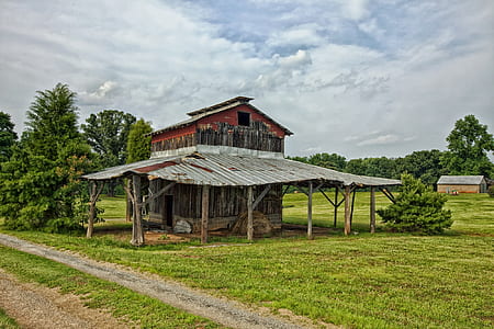 brown house surrounded by grass thumbnail