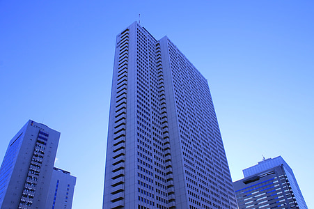 low angle photo of white high-rise building under blue sky at daytime thumbnail