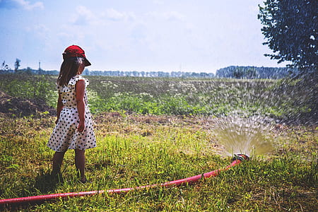 girl watching water flows on water hose thumbnail