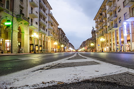 gray paved road between buildings thumbnail