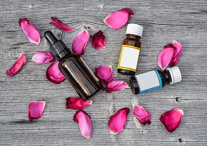 three amber bottles near petals thumbnail