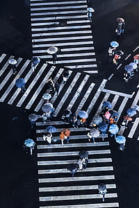 tilt shift photography of people crossing pedestrian lane thumbnail