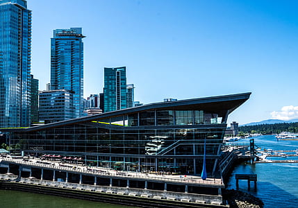 gray and black buildings near body of water thumbnail