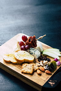 sliced breads and skewered meat on wooden chopping board thumbnail