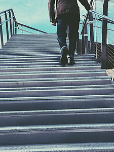 Man Walking on Gray Stairs thumbnail