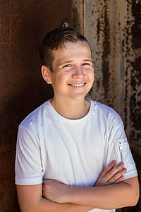 smiling boy wearing white crew-neck t-shirt thumbnail