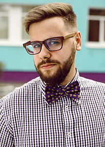 man wearing brown framed eyeglasses and purple bowtie thumbnail