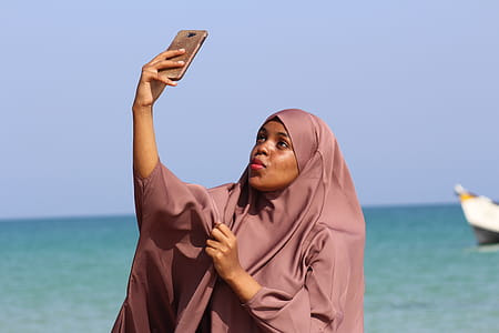 Woman Taking Selfie Near Shoreline thumbnail
