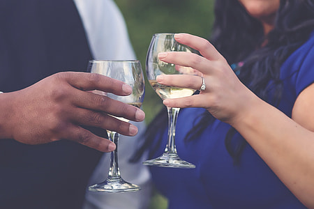 man and woman holding wine glasses thumbnail