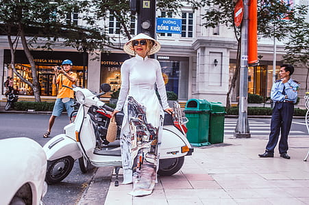 Woman Standing Beside Motor Scooter thumbnail