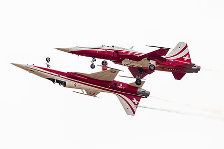 two white-and-red jet performing aerial exhibition thumbnail