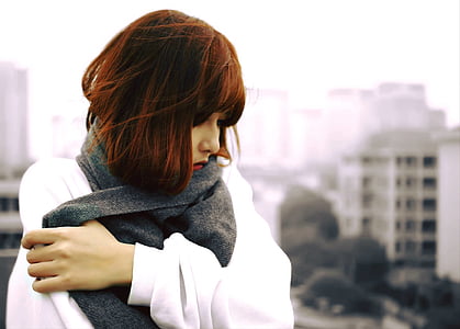 woman wearing white jacket holding black scarf thumbnail