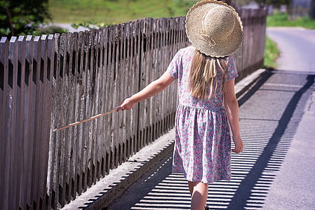 photo of woman wearing purple floral sundress walking on road thumbnail