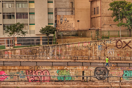 photo of painted walls on street beside building during daytime thumbnail