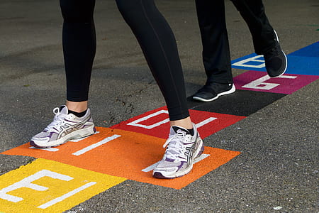 person wearing gray-and-purple Asics running shoes thumbnail