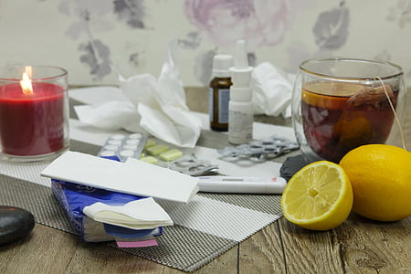 tealight candle, lemons, and tea cup on table thumbnail