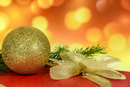 grey glitter bauble beside flower art thumbnail