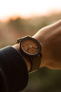 person wearing black analog watch thumbnail